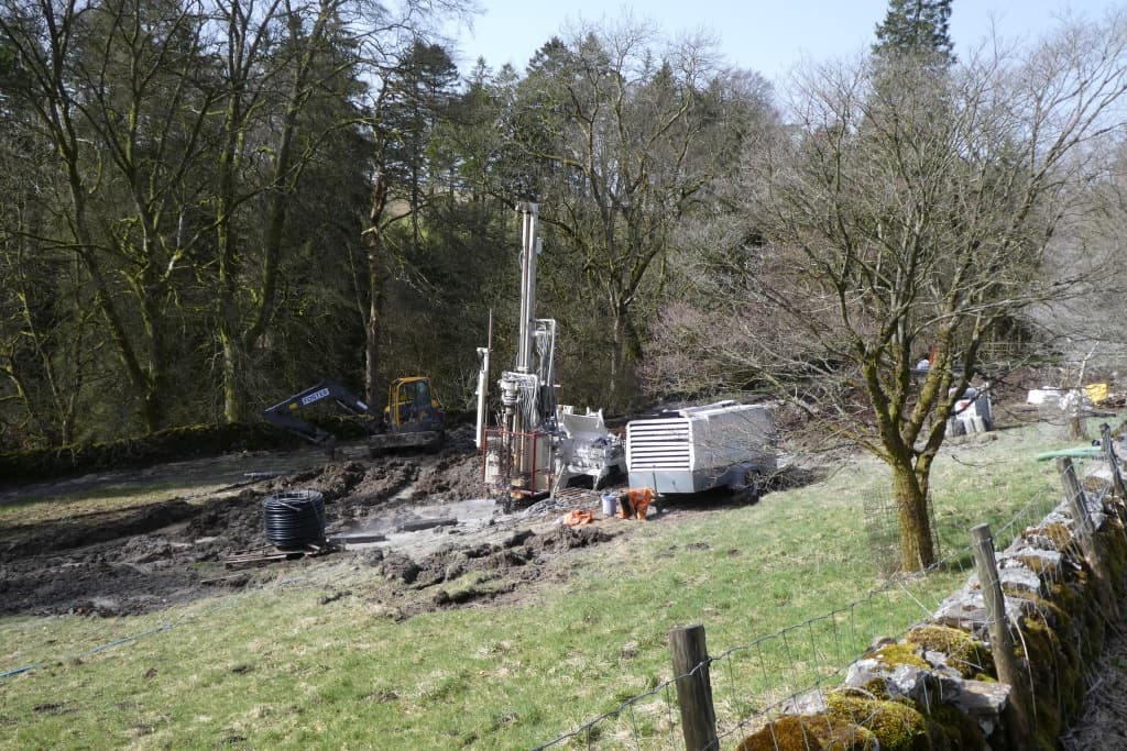A drilling rig set up on a rural site.